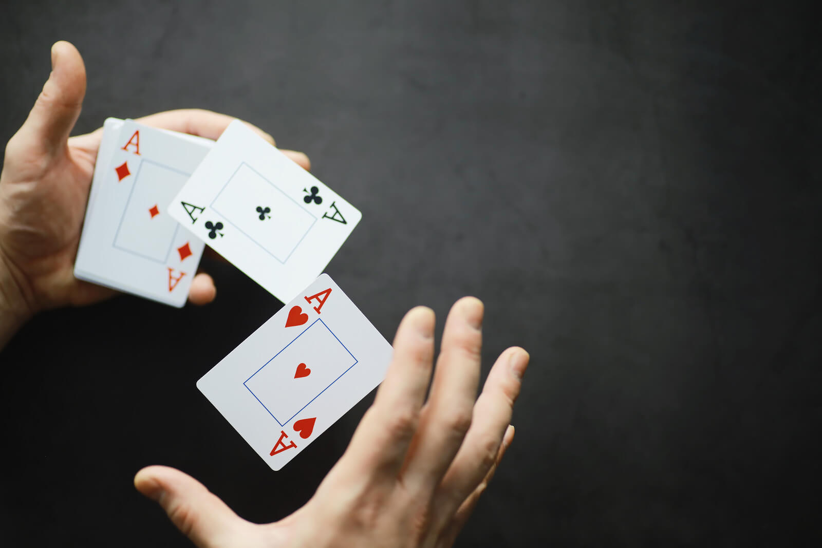 Moving Minds Hypnotherapy - a hand playing with cards
