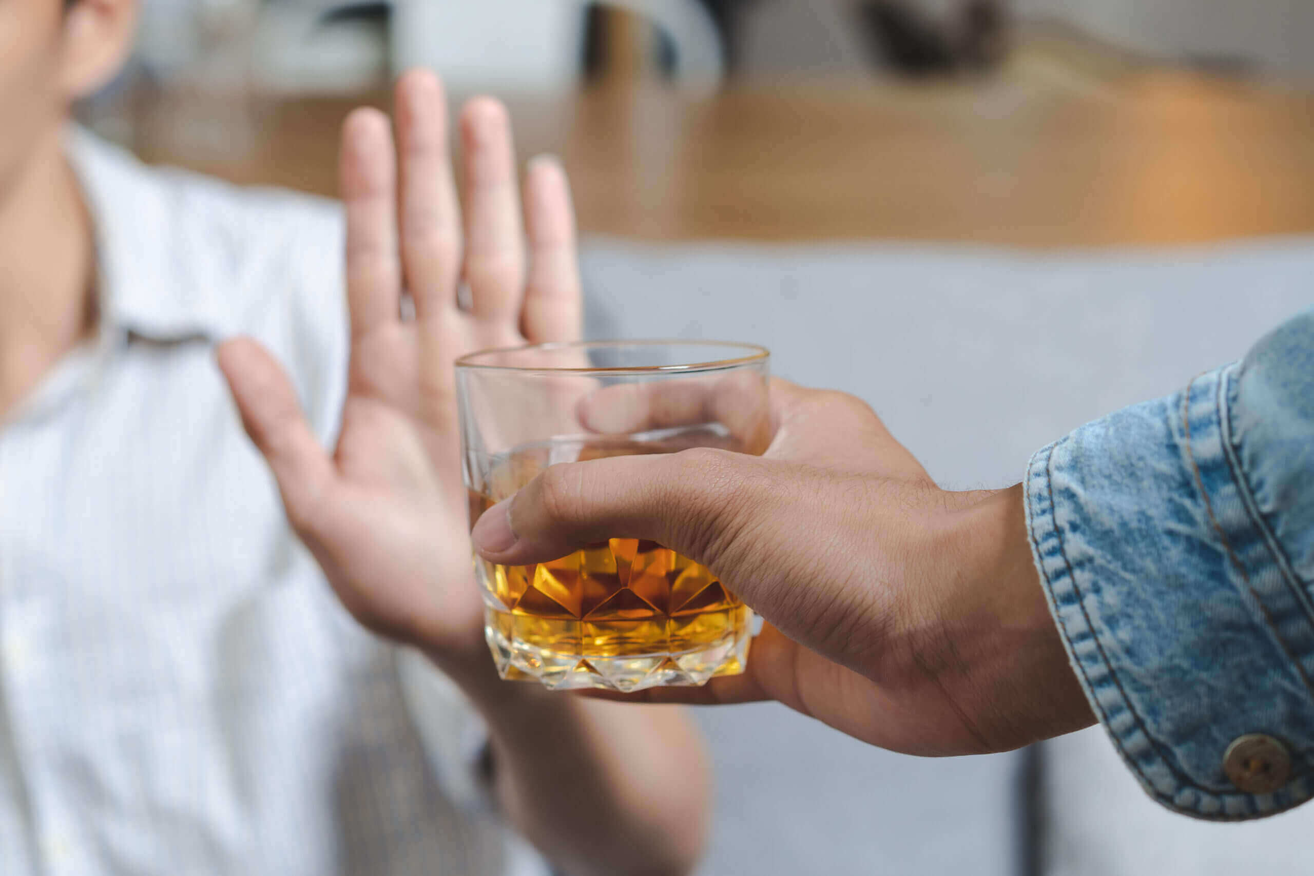 Moving Minds Hypnotherapy - a hand gesture refusing alcohol