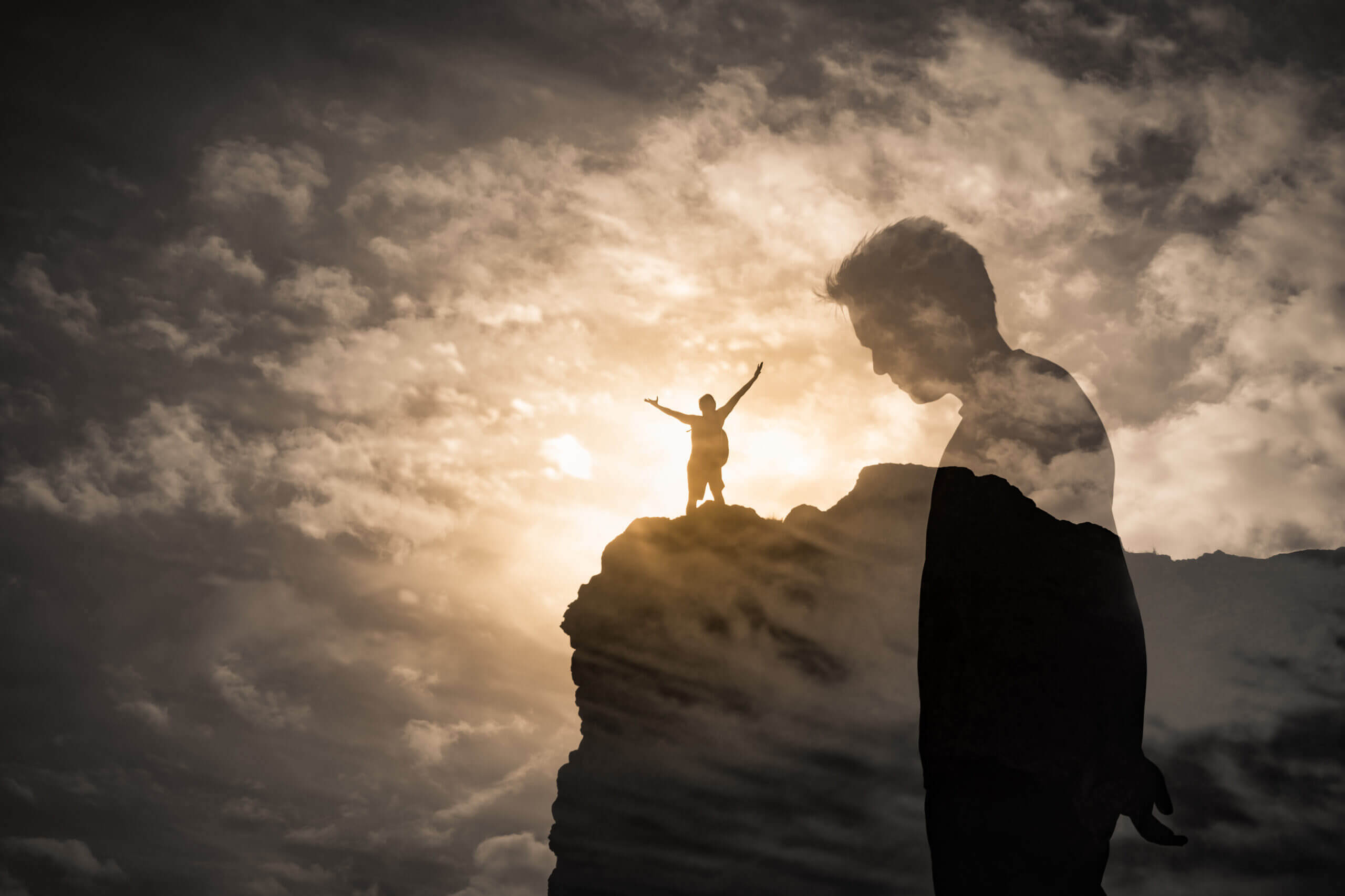 Moving Minds Hypnotherapy - Brave Man Standing On A Mountain Overcoming His Fears Self