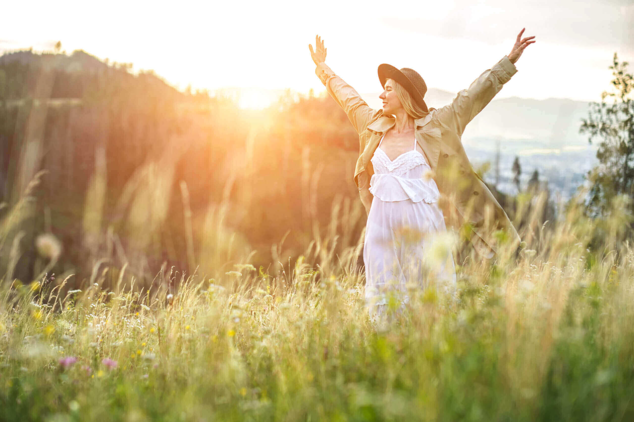 Moving Minds Hypnotherapy - woman spreading her arm to feel the breeze in the forest